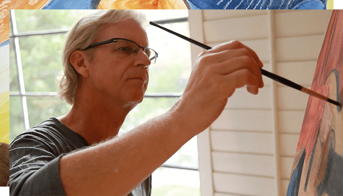 Dr. Butler painting on a canvas