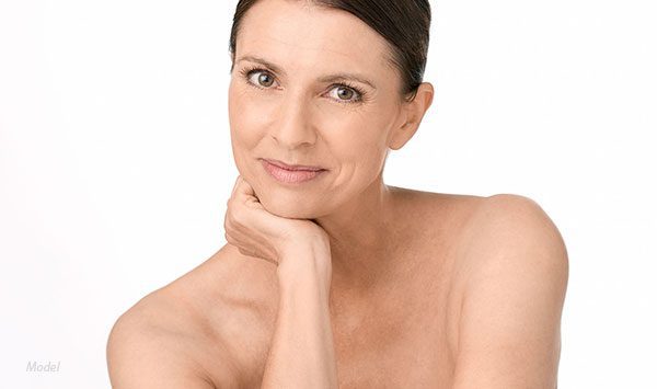 Headshot of middle aged woman with her chin in her hand