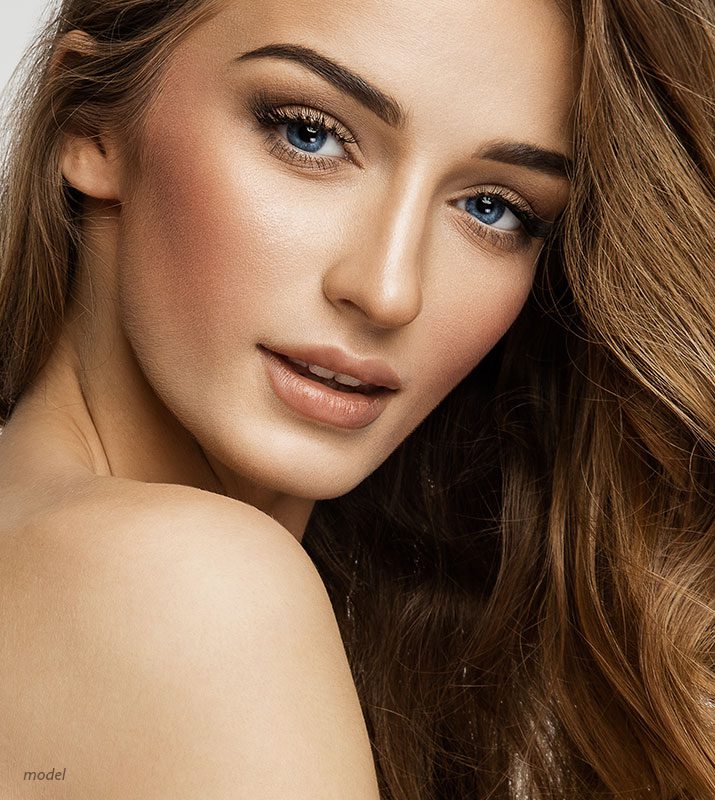 Close up headshot of a woman with blue eyes