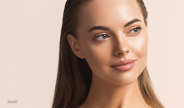 Close up headshot of a female model with her hair slicked back