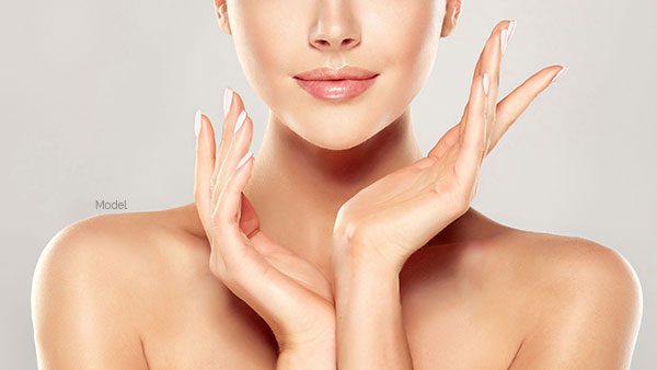 Lower face and shoulders of a female model framing her face