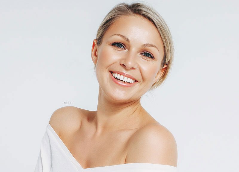 Female model with low cut shirt smiling