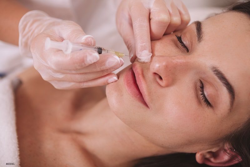 Woman getting injectables in lips.