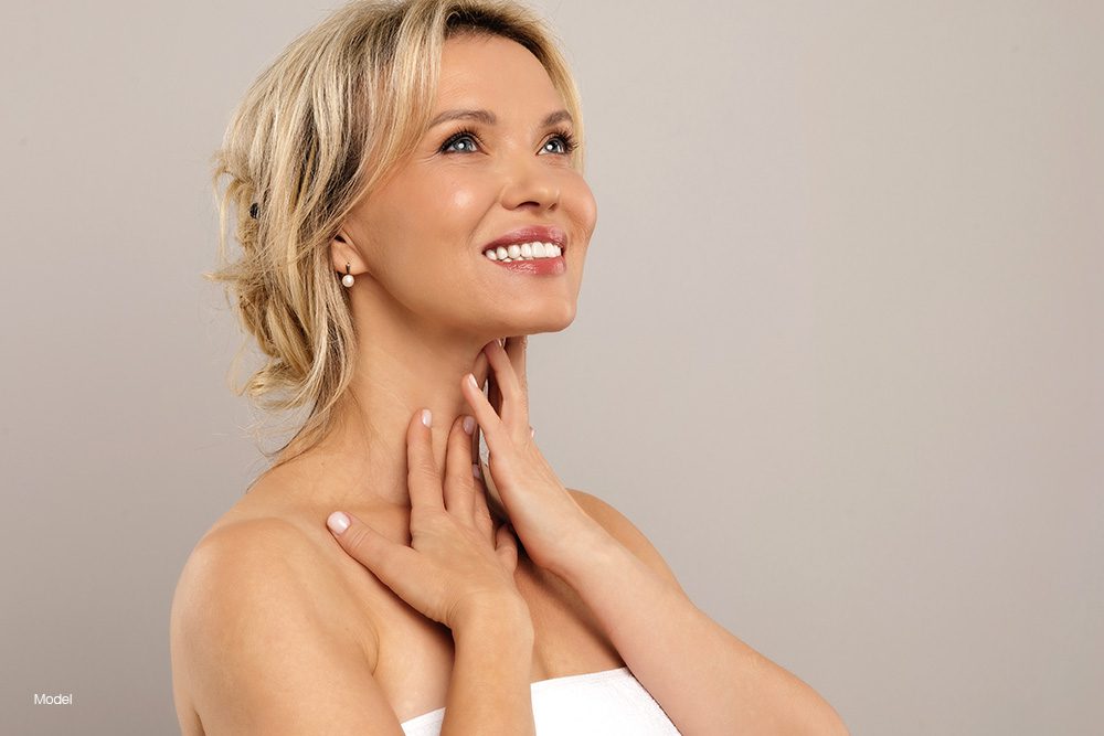 Mature woman touching her neck