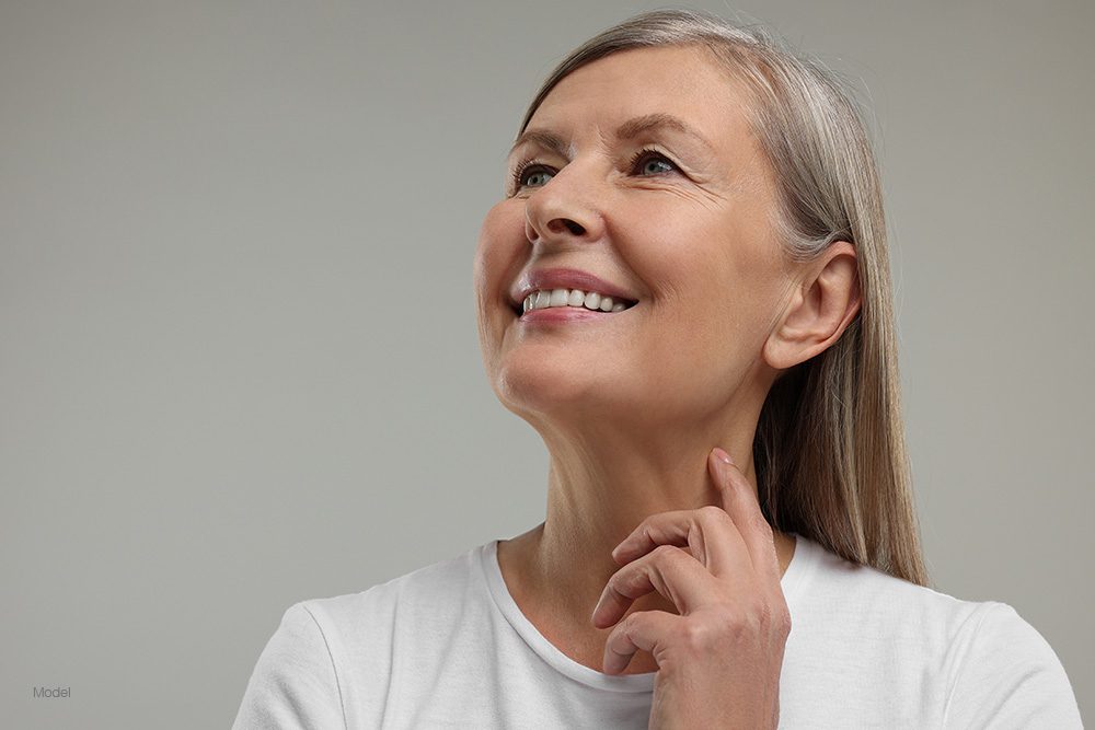 Mature woman touching her neck